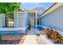 Inviting front entrance with a stylish blue exterior, a bright front door, and tasteful landscaping at 4008 Moreland Dr, Valrico, FL 33596