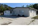 Charming single-story home with a well-maintained exterior, spacious driveway, and a light gray facade at 4802 Drift Tide Dr, New Port Richey, FL 34652