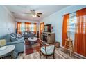 Comfortable living room featuring wood-look floors, a ceiling fan, and ample seating for relaxation and entertainment at 509 N Washington Ave, Clearwater, FL 33755