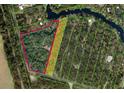 Aerial view showing home nestled on a large lot surrounded by mature trees and outlined property lines at 5540 Cyril Dr, Dade City, FL 33523