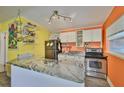 Bright kitchen featuring granite countertops, stainless steel appliances, and white cabinetry, ready for culinary adventures at 5840 39Th N St, St Petersburg, FL 33714