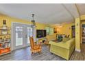 The living room has wood-look floors, and an abundance of natural light coming through the french doors to the patio at 5840 39Th N St, St Petersburg, FL 33714