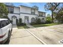 Charming townhome exterior showcasing multiple units, allocated parking, and mature trees for curb appeal at 603 Bainbridge Dr, Brandon, FL 33511