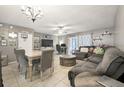 Spacious living room featuring a dining area, ceiling fan, and sliding glass door for natural light at 603 Bainbridge Dr, Brandon, FL 33511