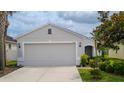 Inviting single-Gathering home with a manicured lawn, a two-car garage and a welcoming entryway at 7120 Forest Mere Dr, Riverview, FL 33578