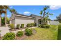 Charming single-story home featuring lush landscaping and a welcoming front entrance with an arched doorway at 7120 Forest Mere Dr, Riverview, FL 33578