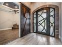 Inviting foyer featuring wood-look tile, decorative front door and rustic sliding barn door at 7162 Graybrook Dr, Wesley Chapel, FL 33545