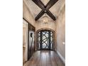 Elegant foyer with wood-look tile flooring, decorative chandelier, and rustic barn door at 7162 Graybrook Dr, Wesley Chapel, FL 33545