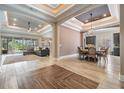 Open-concept living room showcasing stylish tile flooring, decorative ceilings, and lots of natural light at 7162 Graybrook Dr, Wesley Chapel, FL 33545