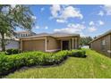 Charming single-story home featuring fresh landscaping and a convenient two-car garage at 8020 Carriage Pointe Dr, Gibsonton, FL 33534