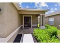 Welcoming entryway with a brick-lined porch and manicured landscaping at 8020 Carriage Pointe Dr, Gibsonton, FL 33534