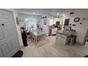 Open floor plan with kitchen island and dining area with charming decor and wood-look tile flooring at 8630 Mallard Reserve Dr # 105, Tampa, FL 33614