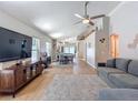 Open-concept living room featuring wood-look floors, neutral walls, and a comfortable gray sofa at 8717 Persea Ct, Trinity, FL 34655