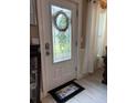 Elegant front door featuring a decorative glass window and a 'Hello' welcome mat at 906 Ponce De Leon Blvd, Belleair, FL 33756