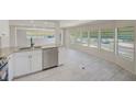 Bright, open-concept kitchen featuring new stainless appliances and laminate flooring at 9790 66Th N St # 37, Pinellas Park, FL 33782