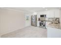 Bright kitchen features stainless steel appliances, granite counters, and an adjacent back door at 9790 66Th N St # 37, Pinellas Park, FL 33782