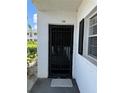 Front door with black security gate and trim, next to the window at 102 47Th Avenue W Dr # 136, Bradenton, FL 34207