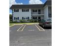 View of the building exterior with a car parked in a designated parking spot at 102 47Th Avenue W Dr # 136, Bradenton, FL 34207