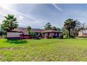 Inviting single-story home with brick accents, manicured lawn and lush landscaping enhancing curb appeal at 10365 Lynnhaven Rd, Spring Hill, FL 34608