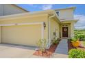 Charming two-story home with an attached garage, a well-maintained lawn, and a welcoming front entrance at 10830 Verawood Dr, Riverview, FL 33579