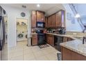 Well-equipped kitchen featuring modern appliances, granite countertops, and a functional layout with laundry access at 10830 Verawood Dr, Riverview, FL 33579