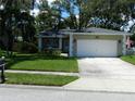 Inviting single-story home featuring manicured lawn and traditional architectural details at 1212 Rosewood St, Largo, FL 33770