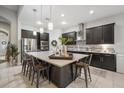 Spacious kitchen featuring dark cabinetry, stainless steel appliances, and an island with seating at 13821 Moonstone Canyon Dr, Riverview, FL 33579