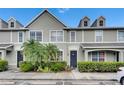 Charming townhome featuring manicured landscaping, a well-lit walkway, and neutral exterior paint at 13905 Abbey Ln, Largo, FL 33771