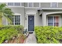 Close-up of the home's front entrance, showing neat landscaping and a charming front door at 13905 Abbey Ln, Largo, FL 33771