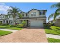 Attractive two-story home with manicured landscaping, brick driveway, and inviting curb appeal at 19209 Long Lake Ranch Blvd, Lutz, FL 33558