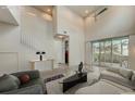 Bright living room featuring high ceilings, a ceiling fan, and large sliding glass doors at 1976 Marlington Way, Clearwater, FL 33763