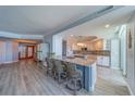 Bright, modern kitchen features an island with barstool seating and stylish backsplash at 2 Seaside Ln # 801, Belleair, FL 33756