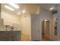 Bright open floorplan with kitchen view, skylight, vaulted ceiling and an arched doorway at 21544 Clubside Loop, Lutz, FL 33549