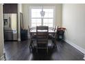 Well-lit dining area featuring a wooden table with cushioned chairs and a view of stainless steel appliances at 2575 W Platt St, Tampa, FL 33609