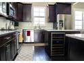 Modern kitchen featuring stainless steel appliances, dark wood cabinets, and marble countertops at 2575 W Platt St, Tampa, FL 33609