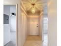 Bright hallway with ceramic floors and a contemporary light fixture at 2937 Stilwell Ct, New Port Richey, FL 34655