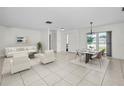 Bright and spacious living room featuring neutral decor, tile flooring, and a view of the outdoors at 3411 Glossy Ibis Ct, Palm Harbor, FL 34683