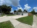 A charming single-story home featuring an attached garage, long driveway, and a well-maintained lawn at 3803 43Rd N Ave, St Petersburg, FL 33714