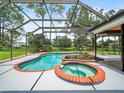 Inviting screened pool and spa area perfect for relaxation and entertaining at 4118 Carrollwood Village Dr, Tampa, FL 33618