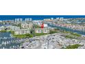 Aerial view of a condo in a vibrant waterfront community with extensive boat storage and nearby amenities at 423 150Th Ave # 1501, Madeira Beach, FL 33708