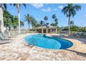 Inviting kidney bean pool area features lounge chairs, a spa, and a shaded pavilion for relaxing by the water at 423 150Th Ave # 1501, Madeira Beach, FL 33708