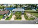 Two-story waterfront home with a convenient two-car covered parking and lush landscaping at 4279 Newport Dr, Hernando Beach, FL 34607
