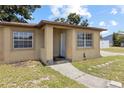 Inviting front entrance with a walkway leading to the front door, and a small covered porch at 525 38Th S St, St Petersburg, FL 33711