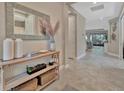 Spacious foyer featuring tile flooring, decor shelving, and a view of the living spaces at 5320 Morey Farms Loop, Palmetto, FL 34221