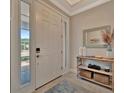 Bright foyer featuring tile flooring, decor shelving, and a view of the front yard at 5320 Morey Farms Loop, Palmetto, FL 34221