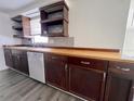 Well-lit kitchen with wooden countertops, dark cabinets, and modern appliances at 5507 Casino Dr, Holiday, FL 34690