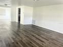 Spacious living room featuring modern wood-look floors and a neutral color palette at 5507 Casino Dr, Holiday, FL 34690