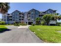 Attractive condo complex with mature landscaping and a covered entry at 5722 Biscayne Ct # 107, New Port Richey, FL 34652