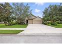 Beautiful two-story home featuring a wide driveway, a three car garage and a well-maintained lawn at 5962 Lexington Dr, Parrish, FL 34219