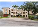 The exterior showcases the home's inviting facade, complemented by mature trees and lush landscaping at 6 Academy S Way # 221, St Petersburg, FL 33711